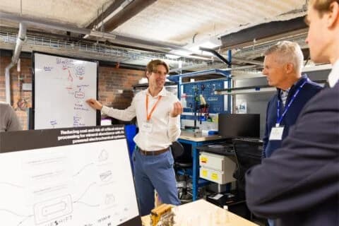 A founder demoing hardware to attendees at the 2025 Boston Climatetech Summit