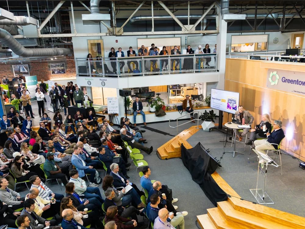 A packed crowd watching a panel discussion at Greentown Labs