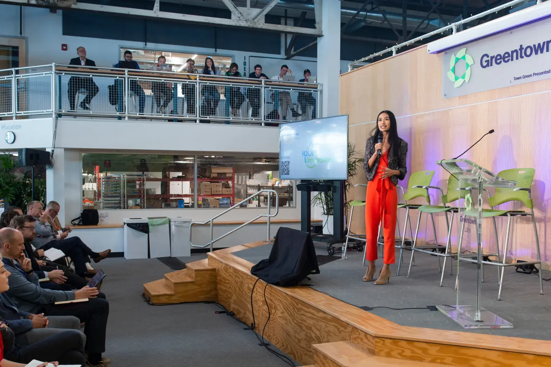 Speaker presenting on stage at a Greentown event