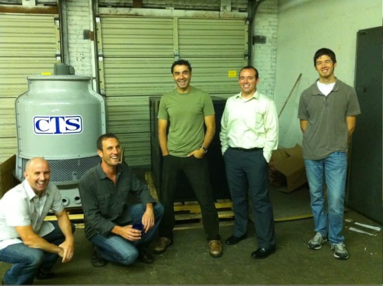 The founders of Greentown Labs’ original four startups posing together in the Cambridge warehouse