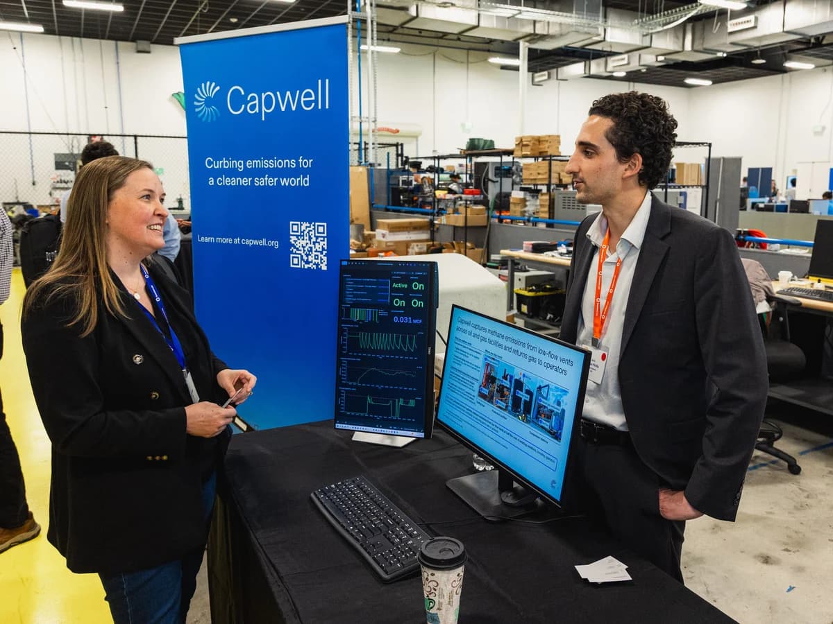 Attendees discussing a Capwell methane-emissions-capture demo at a past Greentown Houston event