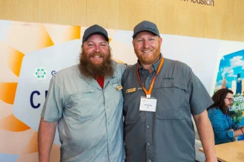 Two attendees posing together at a past Greentown Houston Climatetech Summit