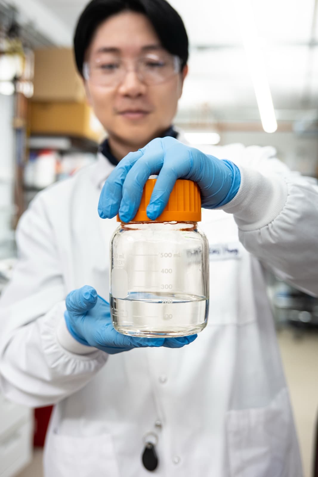 Researcher holding a lab sample bottle at Greentown Labs