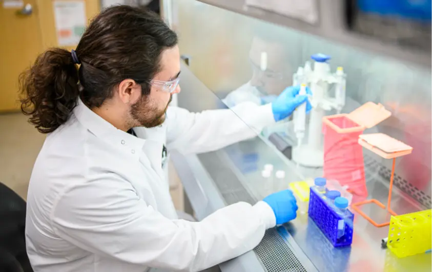 Entrepreneur working at a fume hood in a prototyping lab