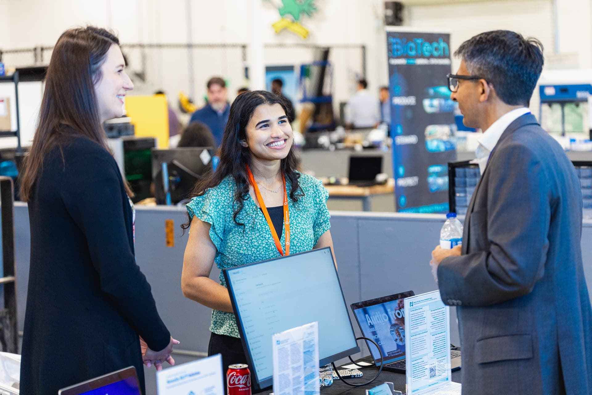 Attendees connecting at a startup booth during the Climatetech Summit